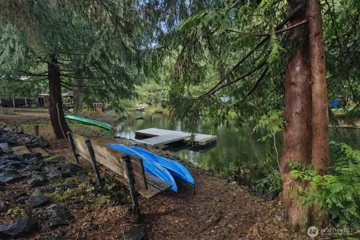 Serene canal frontage featuring a private dock and easy water access, perfect for kayaking and relaxing by the water.