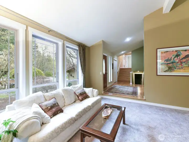 Natural light floods the living room, overlooking the front garden space.