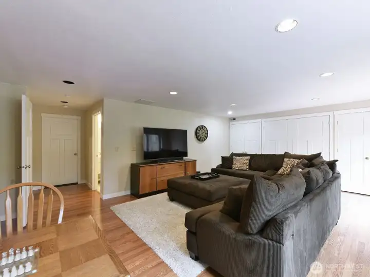 Basement rec room with a whole wall of closets!  What would you do with this space?