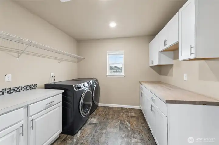 Laundry room with lots of cabinets and counter space!