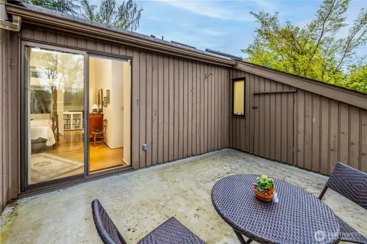 The private patio off the primary suite offers a quiet outdoor retreat with space for seating and relaxation. Two large storage areas provide exceptional convenience, adding valuable functionality to this peaceful, tucked-away space.