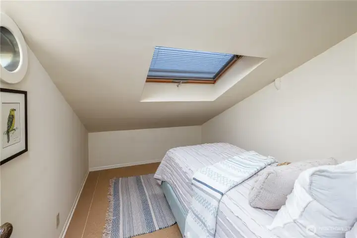 Tucked above the third bedroom, this cozy loft offers a unique and flexible bonus space, ideal for guests, a quiet reading retreat, or creative use. With its skylight and intimate feel, it’s a charming hideaway that adds both character and versatility to the home.