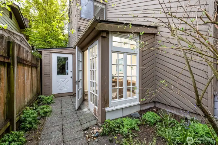 Just off the back deck, a charming garden room provides a peaceful space to relax, work, or enjoy the surrounding greenery. Adjacent, a separate potting shed and storage area offers excellent functionality for gardening enthusiasts, keeping tools organized and easily accessible.