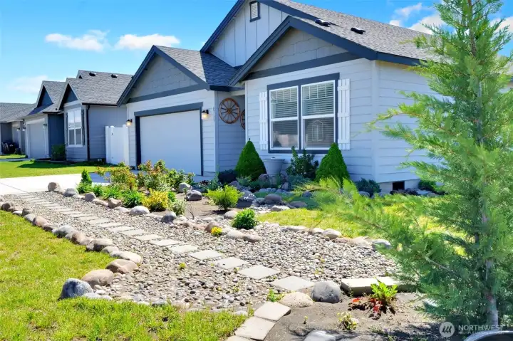 Thoughfully designed front landscaping with low maintenance plantings.
