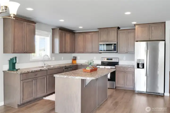 Full kitchen view with generous counter space.