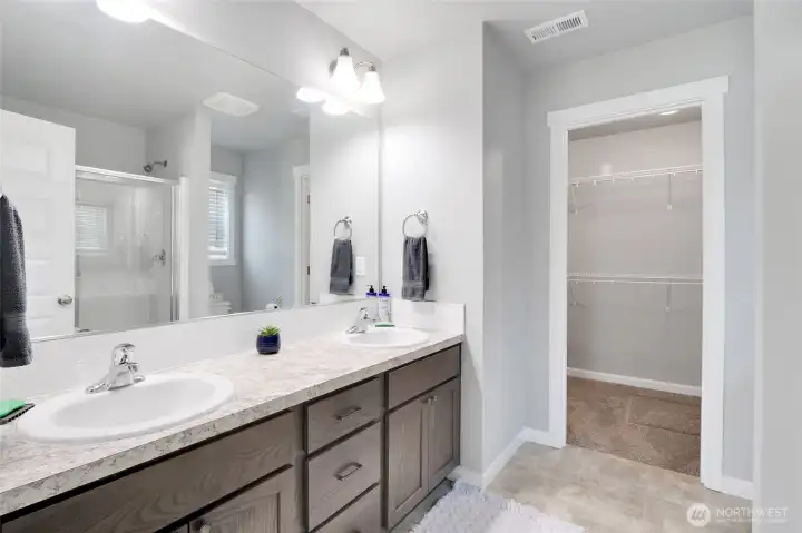 Primary bathroom with dual-sink vanity.