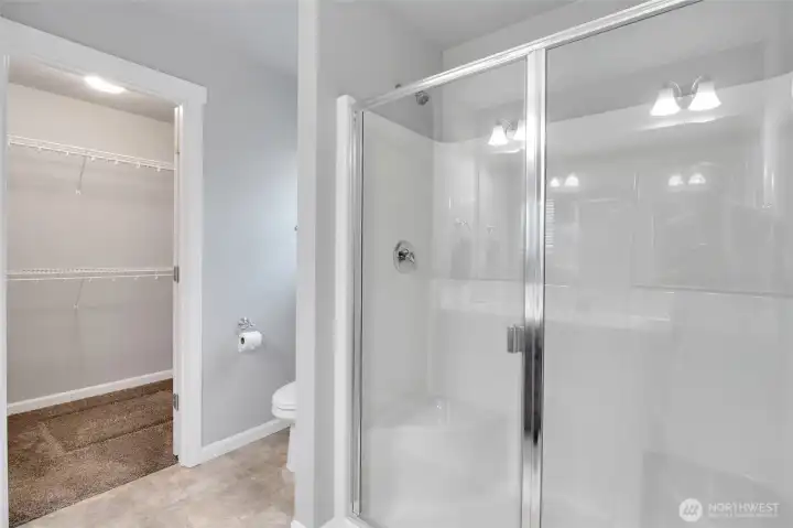 Primary bathroom complete with a clean step-in shower and modern fixtures.