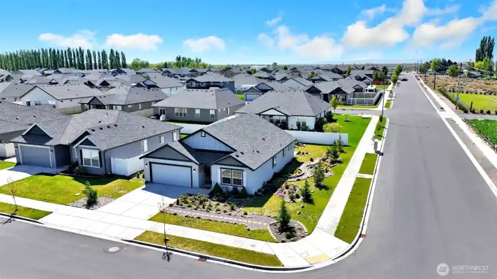 Front exterior wide corner view showing landscaping features.