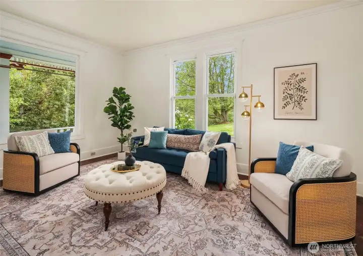 Living room is on the east side overlooking the covered porch that runs the length of the east side of home. Great flow between the main level spaces. High ceilings provide a nice sense of spaciousness.