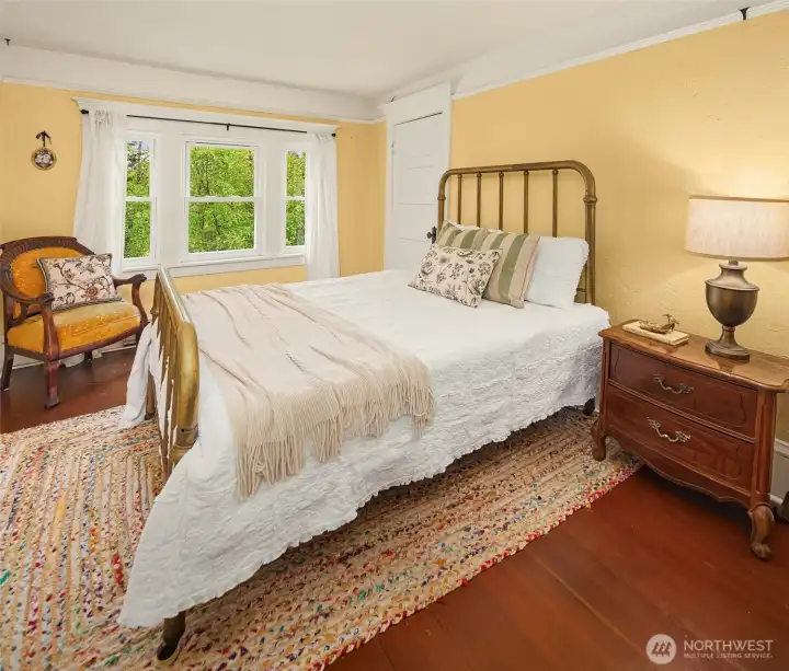Upstairs bedroom on east side of home. Each bedroom has access to a large, walk-in closet. Fir floors, original doors and mouldings.