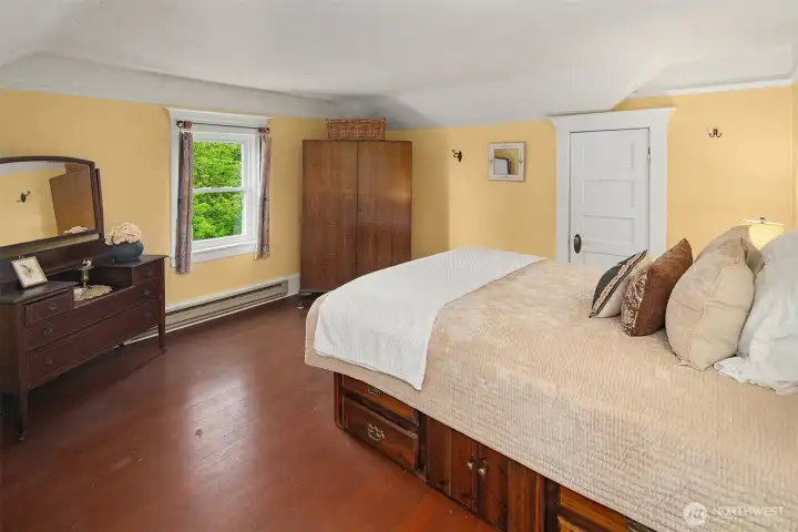 Bedroom on the southwest corner is generous with cove ceilings, large closet, original woodwork and fir floors.