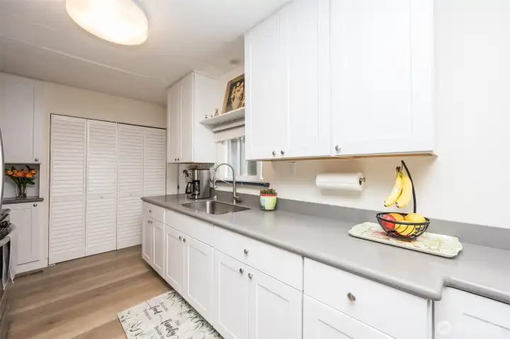 New updated kitchen with quartz countertops.  Washer & Dryer behind  louvered doors