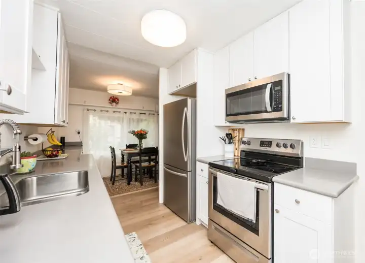 Stainless steel appliances and double sink with new faucet and plumbing