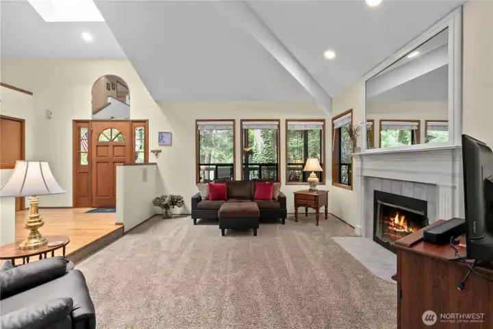 Living room with soaring ceilings and wood-burning fireplace