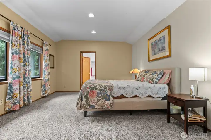 Primary suite has peaceful views of the backyard