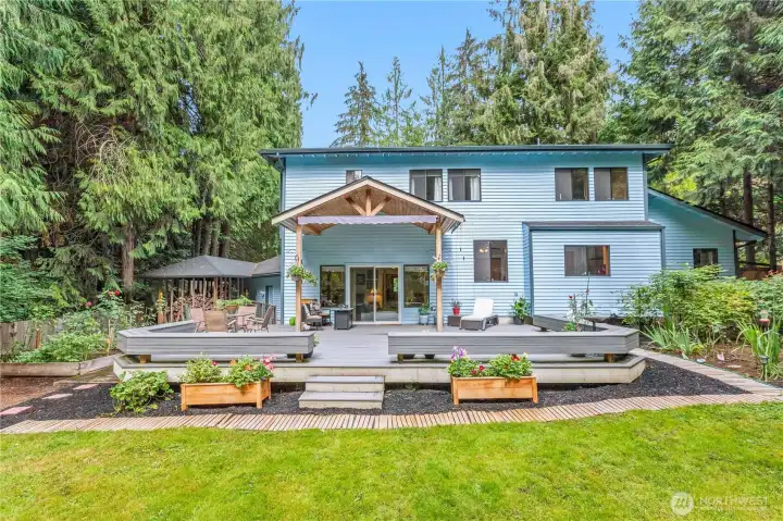 A view of the backyard, entertainer's deck and gardens