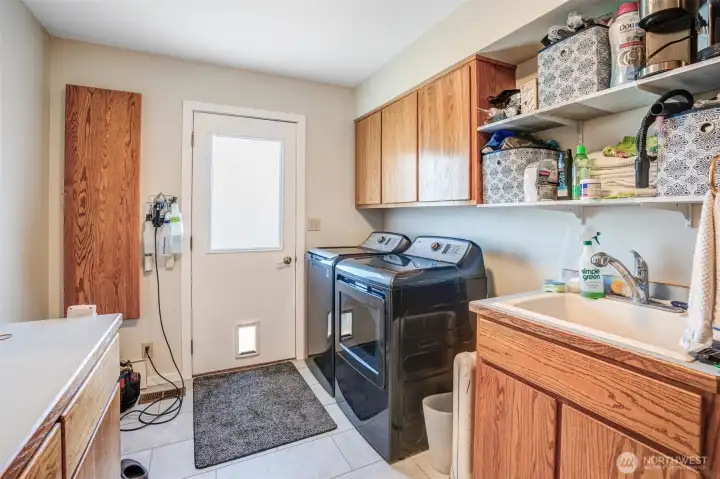 Laundry with access to the back deck- upper floor Laundry with access to the back deck- upper floor