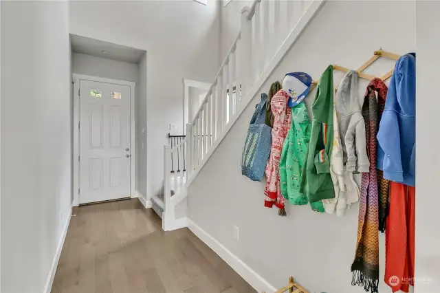 Another view of the entry and over on the stair landing is the access to the 1/2 bath on the main level.