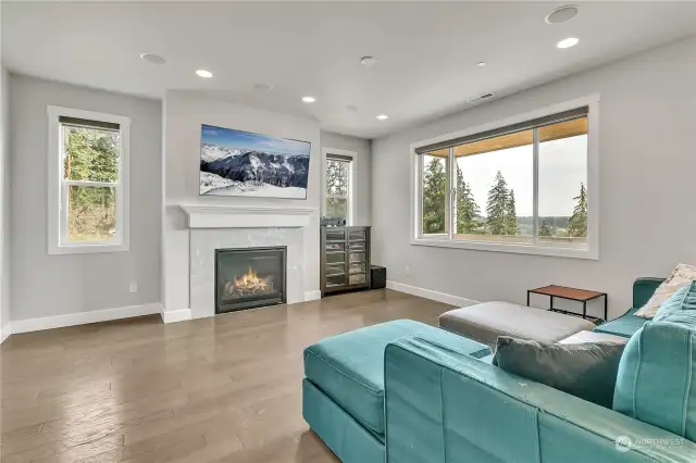 A view of the great room, gas fireplace, and out the window on a clear day you'll get a territorial view and a view of the Cascade Mountains.