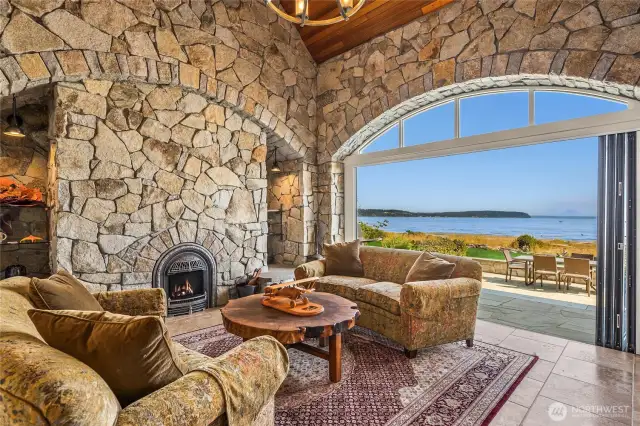 The stone-surrounded sitting room designed for year-round enjoyment of this beautiful view opens up to the patio.