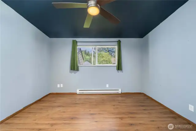 Bedroom features updated flooring, baseboard heat, and a large window that brings in plenty of natural light. Ideal as a guest room, home office, or creative space to suit your lifestyle.