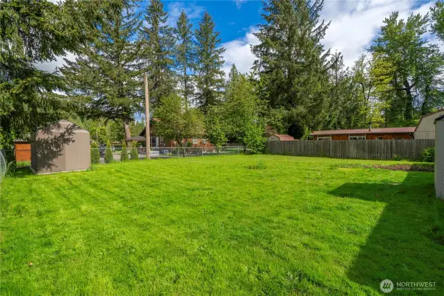 This lush backyard offers multiple storage sheds and ample space to entertain, plant, or play. Endless possibilities await!