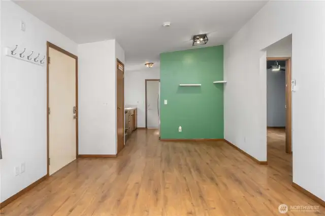 This central hallway ties the home together—connecting bedrooms, bathroom, and kitchen. The accent wall adds character and potential for a creative workspace, play area, or dining nook.