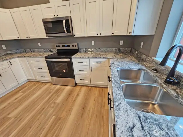 Convenient kitchen offers rich granite countertops. Upgraded fixtures.
