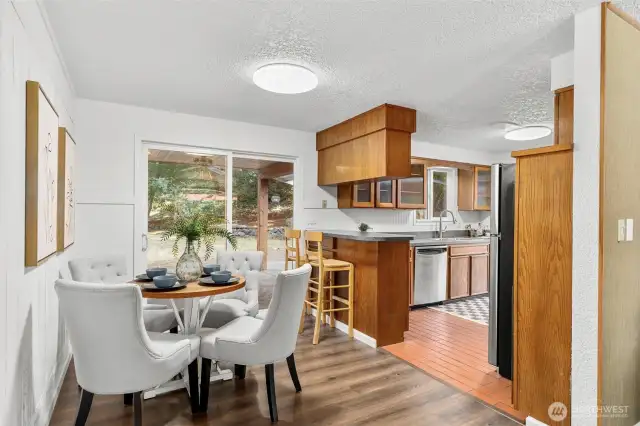 Dining room adjacent to kitchen with backyard access