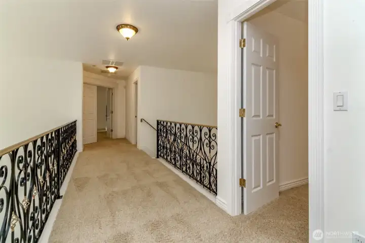 Mezzanine, looking toward primary suite, on right entrance to second bedroom