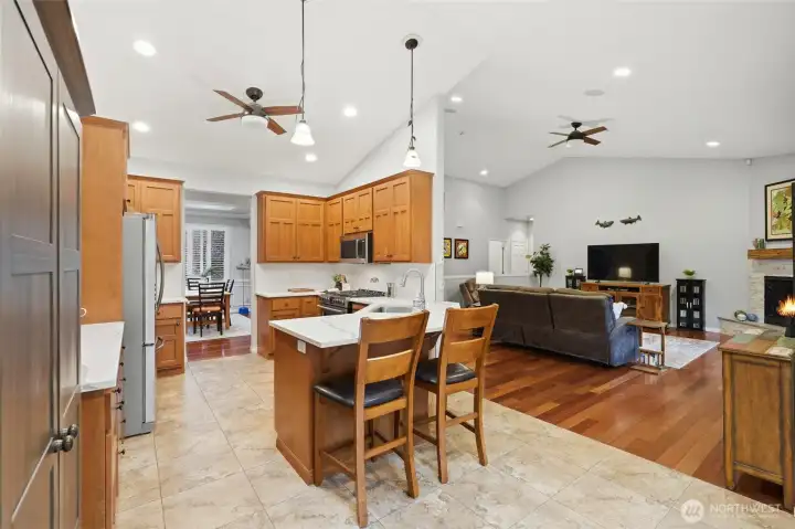 Open-concept kitchen flowing to the family room, breakfast nook, and formal dining.