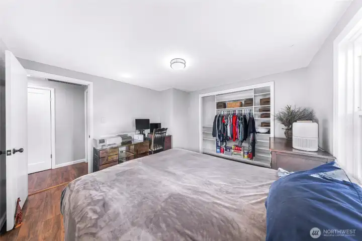 Primary bedroom complete with custom closet shelving in closet.