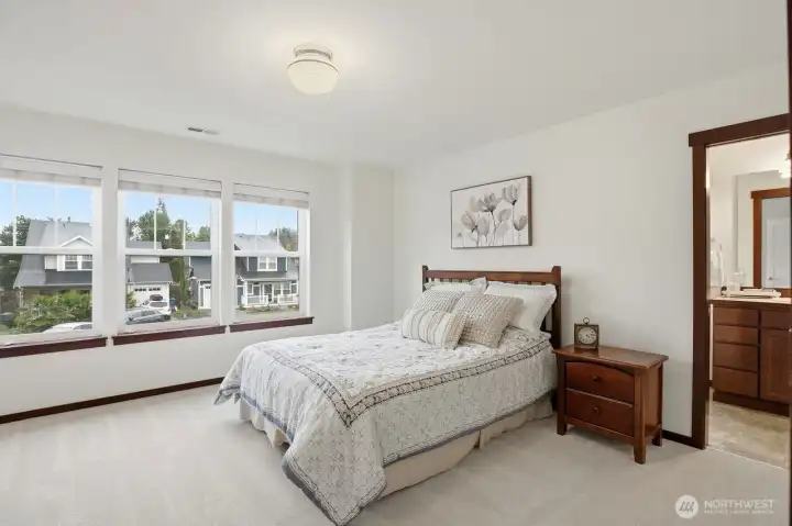 Spacious primary suite with walk-in closet and ensuite bath with shower & separate soaking tub.