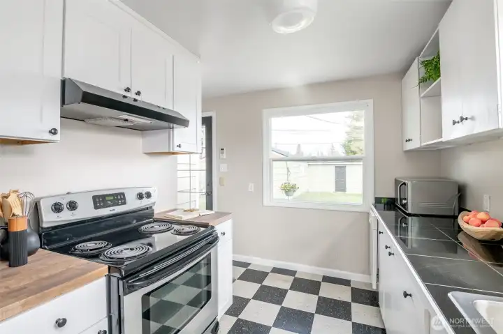 New upper and lower cabinets on the left, with new butcher block countertops.