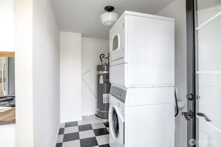 This utility area holds a stackable washer and dryer with room to add storage.