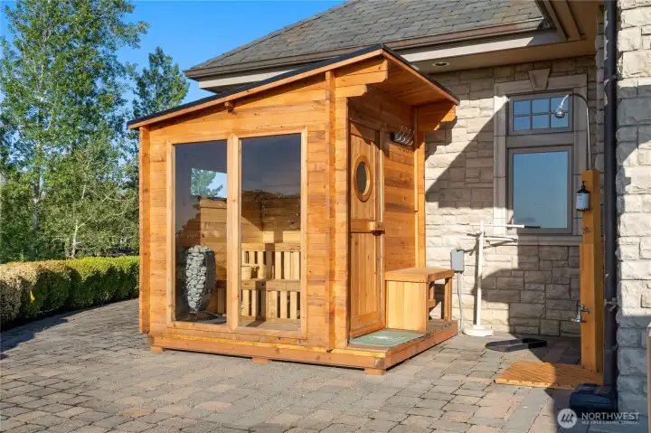 Custom-built sauna with bench seating, amazing lighting and views. Outdoor shower steps away.