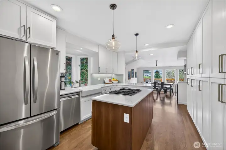 Beautifully remodeled kitchen with natural light, quartz countertops and stainless steel appliances