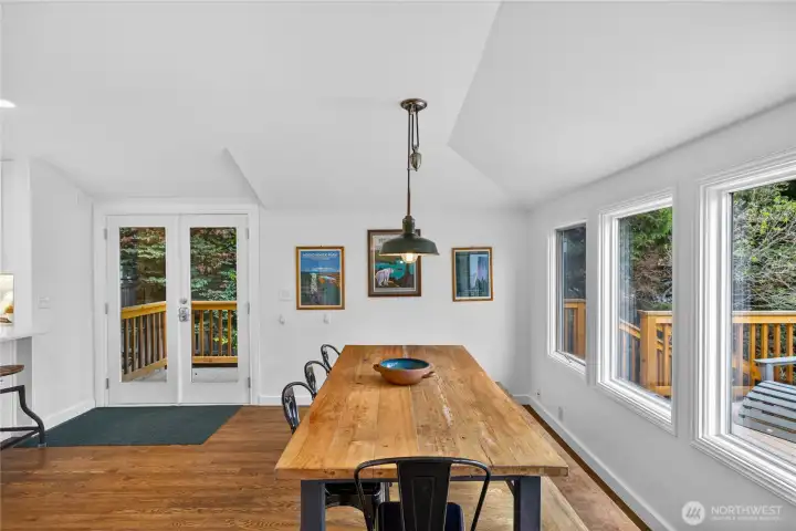 Dining area with large windows and views out to backyard