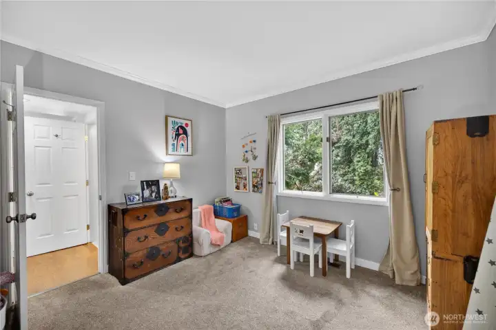 Main level bedroom with south facing window and views out to side yard