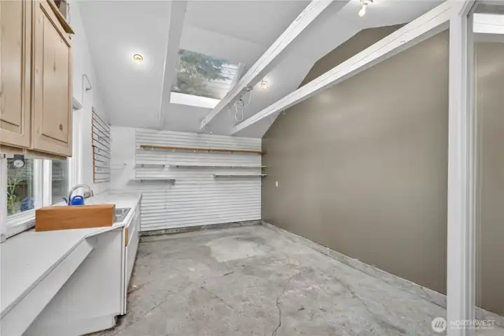 Large shop off the garage with tons of natural light can be used for storage, gardening center, art studio