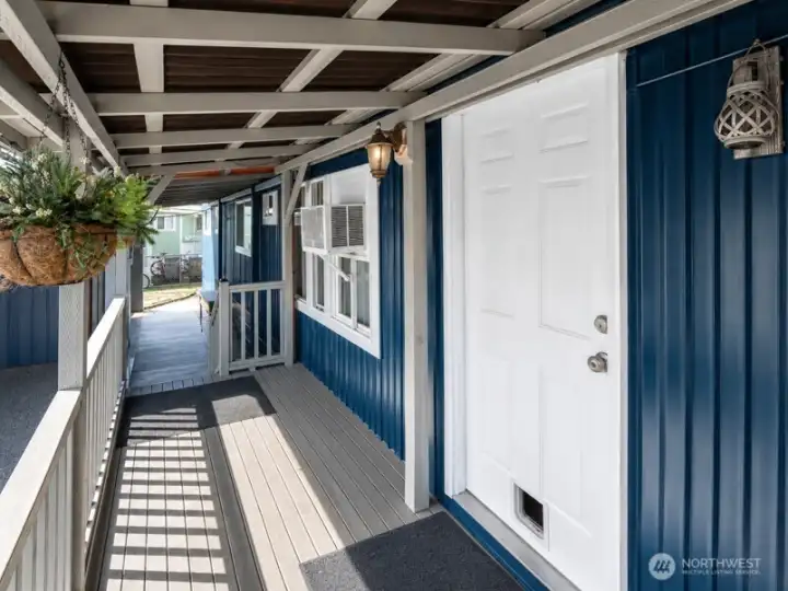 Exterior covered stairway with durable wood-and-concrete base, leading to the home’s elevated side entry.