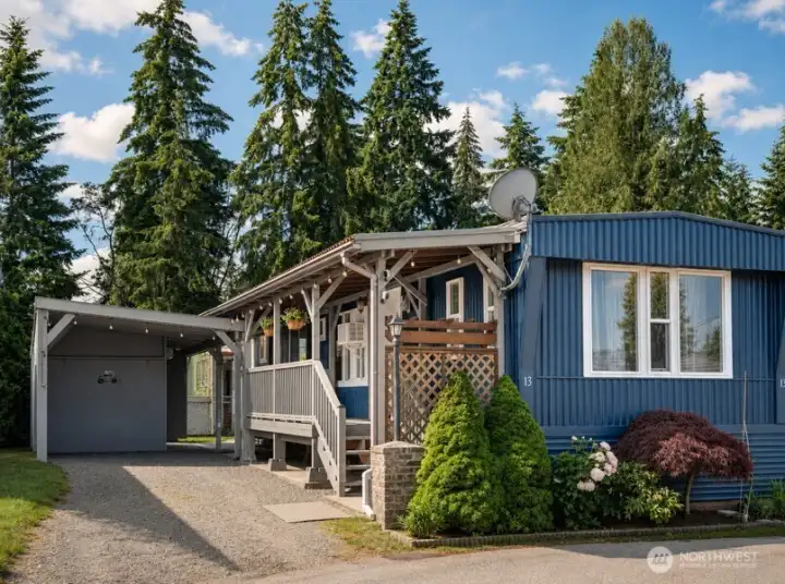 Exterior view of the house with covered porch and attached carport.