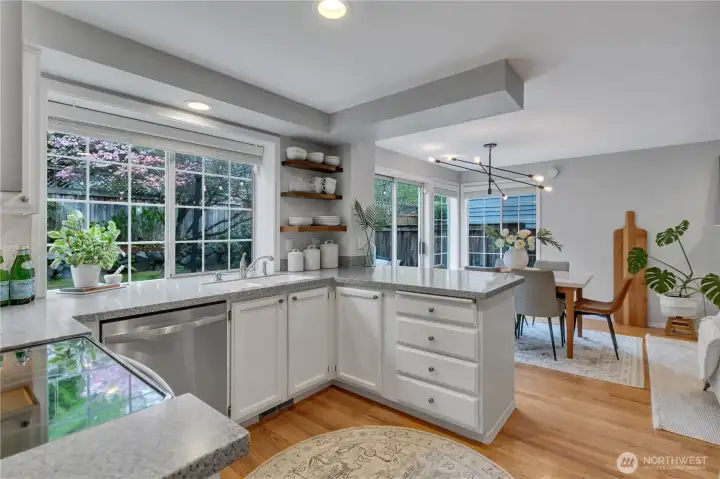 Large window over sink & countertops looks to backyard.  Note blooming dogwood tree!  Cupboards & drawers galore for storage! Pantry & refrigerator behind us.