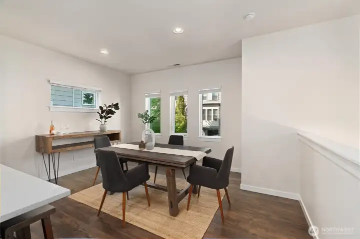 The spacious dining area comfortably accommodates a dining table for six or more, making it ideal for everyday meals and special gatherings.