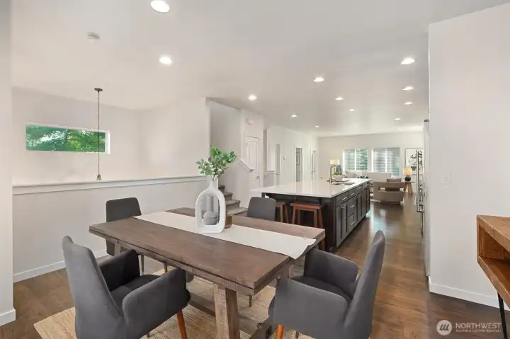The open-concept layout seamlessly connects the dining area, kitchen, and living room, creating an ideal space for everyday living and entertaining.
