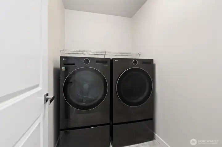 Laundry room conveniently situated on the same level as the primary suite and secondary bedrooms.