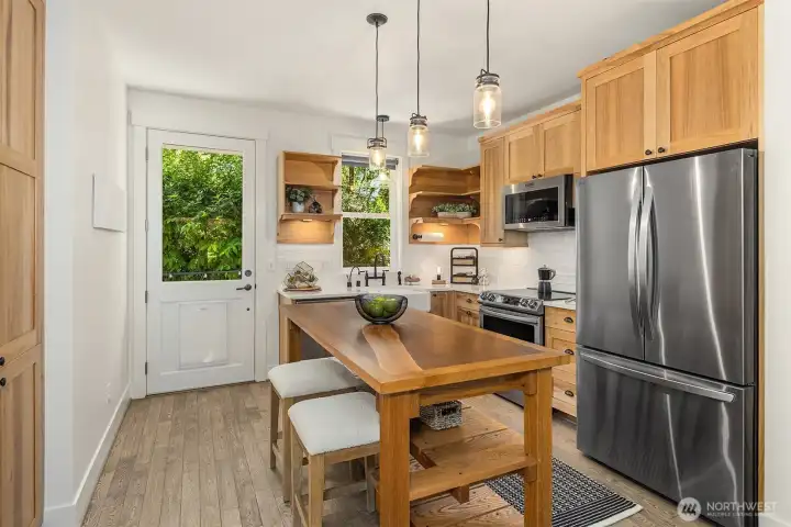 Plenty of cabinet space and workspace in this sweet kitchen. The rear door leads to the composite deck and fenced yard.