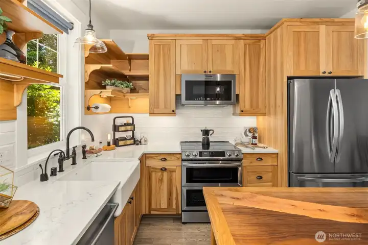 There is a handy Insta-Hot water dispenser and a hidden garbage/recycling cabinet as well.