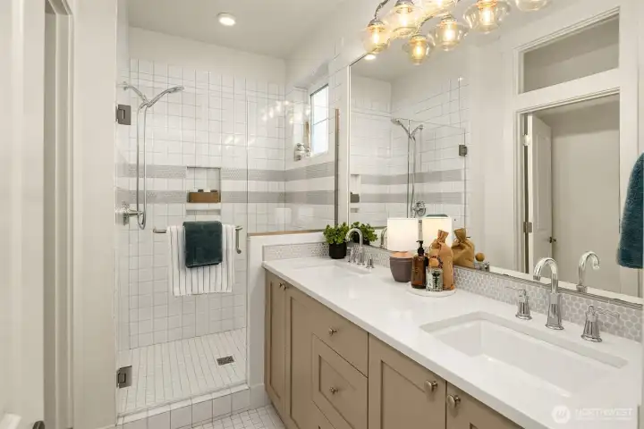 Here is the attached bathroom with dual sinks and separate water closet.
