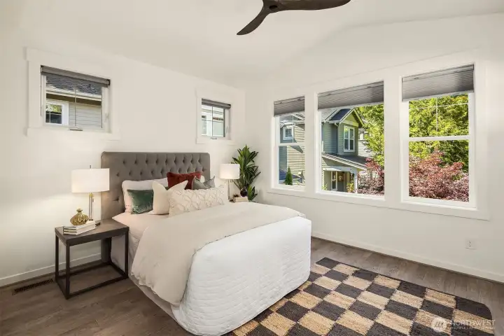 Now we are on the second level, arriving at the spacious primary suite with vaulted ceilings + ceiling fan, walk-in closet, attached bath, and private deck.